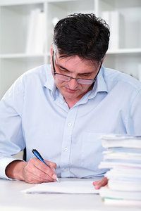 man writing note