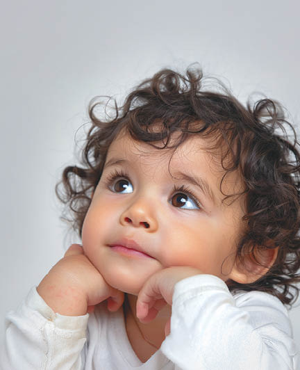 Hispanic toddler, 2-3 years old, with a thoughtful expression, isolated on a white background, pensive mood.